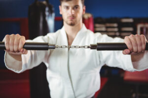 Which martial arts use weapons
